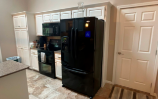 Kitchen cabinets and kitchen door painted in white